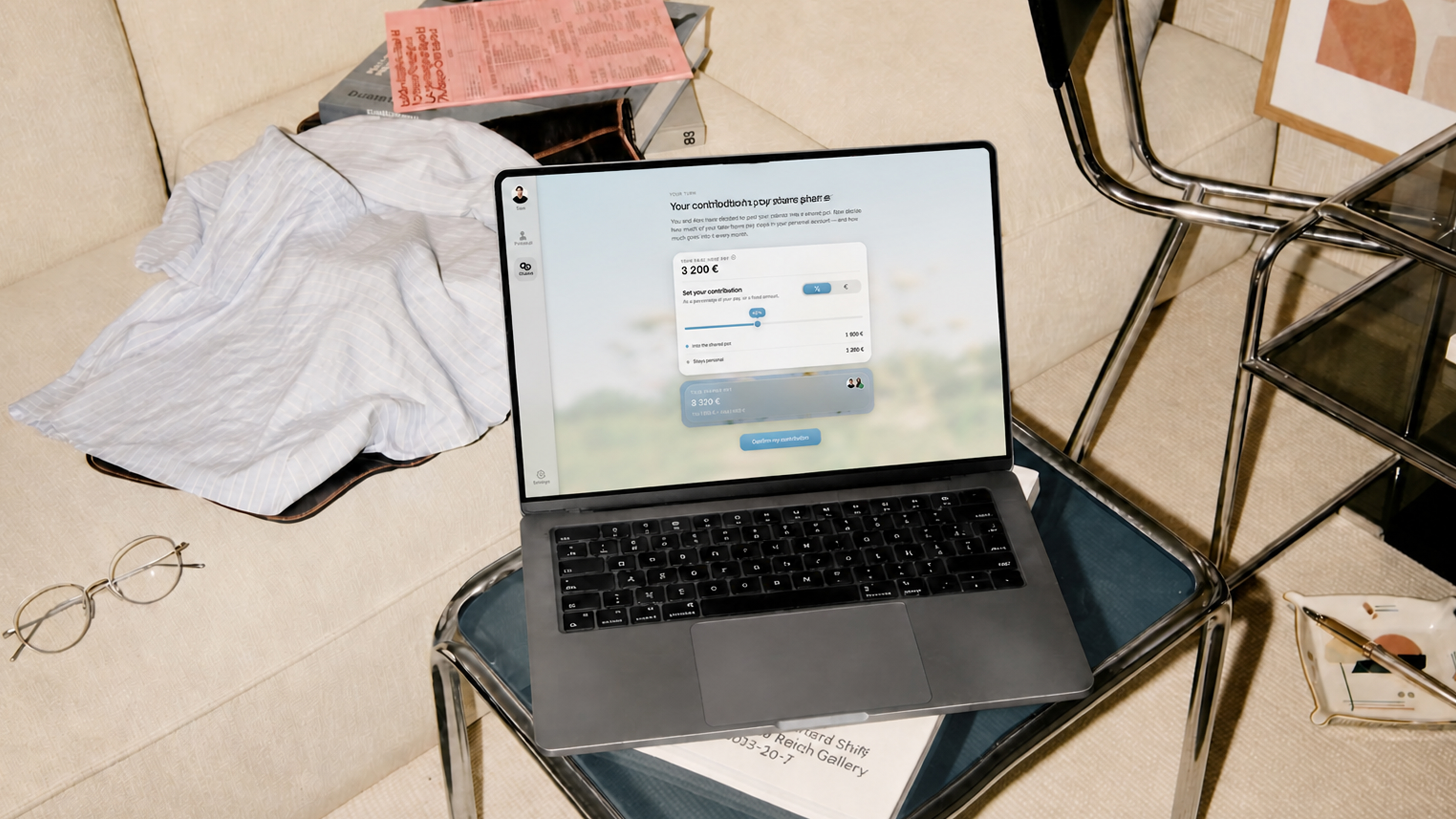 The couples banking app running on a laptop, held up against a blue sky